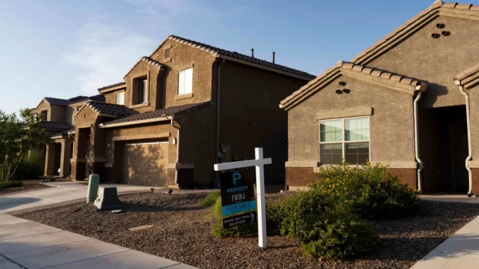Mortgage Rates Climb to a Three Week High as MBA Says Applications Slip and Refinance Demand Falls Further in a Cooler U.S. Purchase Market A house key resting beside mortgage paperwork and a calculator on a table
