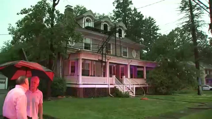 Firefighters respond to an attic fire at a nine-apartment building after a lightning strike in Summit, New Jersey