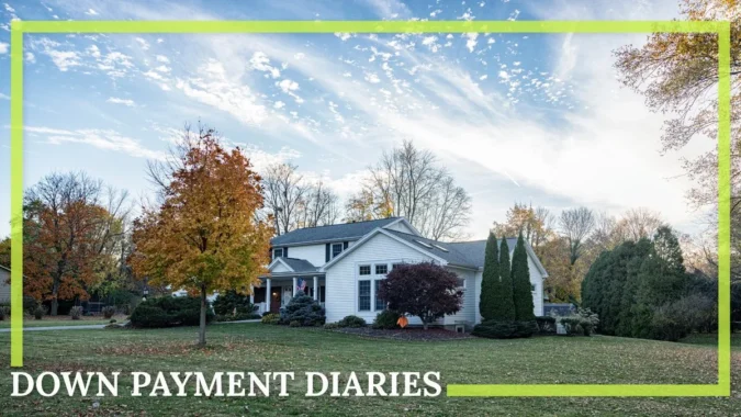 A young Rochester couple in front of a four-bedroom starter home with a fenced backyard