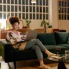 A homeowner reviewing refinance paperwork next to a calculator and house keys