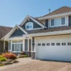 A homeowner reviews mortgage paperwork with a calculator and house keys nearby