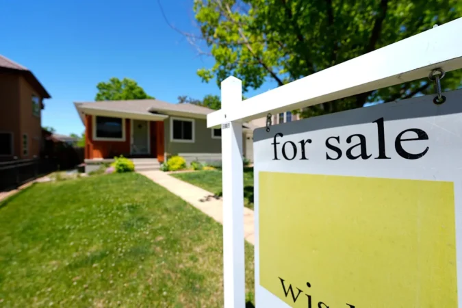 Mortgage Rates Stay Stuck in the Mid Sixes as Freddie Mac Posts 6.65% on a 30 Year Loan and Fannie Mae Sees Little Relief Before 2027 A house for sale sign in front of a suburban home as mortgage rates remain elevated