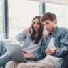 A couple discussing whether to use a settlement payment to pay off their home mortgage