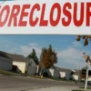 Detroit Family Faces $10,000 HOA Bill and Possible Foreclosure After Brother-In-Law Misses Fees on Condos, Forcing Woman to Consider Selling $50,000 in Stocks A couple reviewing bills and investment account statements on a kitchen table