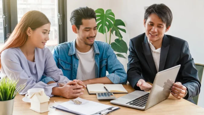 Homebuyers Nationwide Are Pausing House Hunts for Lower Mortgage Rates as a Neighbors Bank Poll Finds 72% on Hold and 41% Already Regretting the Wait A prospective homebuyer reviews mortgage rate listings while a house sits for sale in the background