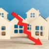 For-sale homes with a real estate sign in a suburban neighborhood
