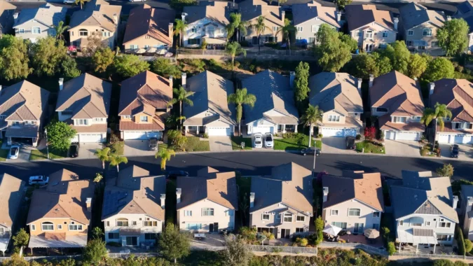 Mortgage Rates Hit Highest Level Since June 2025 as Oil Prices Jump After New Middle East Fighting Pushes Bond Yields Higher Nationwide A for sale sign in front of a suburban home as mortgage rates rise
