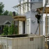 Mortgage Rates Near 7 Percent Push Home Buyers to Wait as 30 Year Loans Hit a 14 Month High and Fed Policy Keeps the Market on Edge For sale sign outside a home as rising mortgage rates make buying less affordable