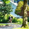 Parents Will Pay More for Walkable School-Area Homes as NAR Survey Finds 63 Percent Want Easy Access to Parks, Shops, and Restaurants Families walking along a neighborhood sidewalk near a school