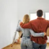 Down Payment Assistance Can Help Buyers Cover Closing Costs and Pair With FHA USDA or Conventional Loans as Middle Income Renters Miss Key Programs A couple reviews home financing papers with a lender at a kitchen table