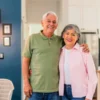 An older couple discusses home renovation plans in a bright kitchen with accessibility features