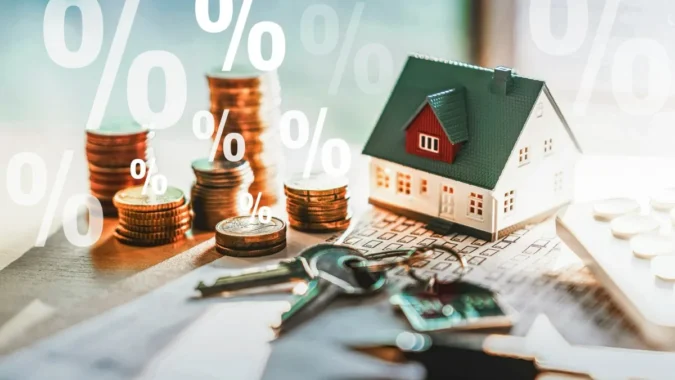Federal Reserve Rate Hike Raises Borrowing Costs for Credit Cards, New Mortgages, Car Loans and Some Student Debt While Savings Rates May Edge Higher A Federal Reserve building with charts showing higher borrowing costs for loans and savings rates