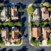 Mortgage Rates Near 7 Percent Are Raising Monthly Costs and Cooling Homebuying Demand as Sales Slow, Sellers Offer More Concessions, and Prices Stay Elevated Nationwide A for sale sign in front of a suburban home as mortgage rates rise and buyers hesitate