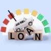 A buyer reviews auto loan paperwork beside a used car at a dealership