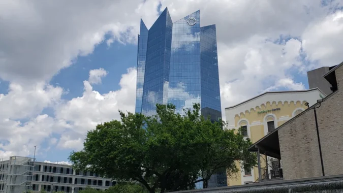 San Antonio homes and a mortgage rate chart beside a lender office