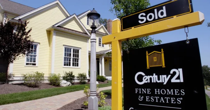 A house for sale sign in a neighborhood as mortgage rates rise
