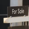 North Texas Mortgage Rates Climb Above 7 Percent as Fort Worth and Dallas Realtors Say Higher Borrowing Costs Could Ease Competition for Buyers A North Texas home for sale sign with real estate listings in the background