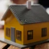 US Mortgage Rates Climb Above 7 Percent as 30 Year Loans Hit 7.49 Percent, Adding About 160 Dollars to Monthly Payments on a 400000 Dollar Home A row of homes with a for sale sign as mortgage rates move above 7 percent