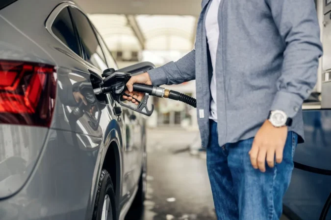 Detroit Airport Rental Car Travelers Can Save About 22 Dollars by Skipping a Gas Station Charging 5.74 a Gallon Near the Return Lot Gas price sign near an airport rental car return area showing a high per-gallon rate