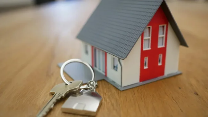 VA Says Veterans Can Reuse Home Loan Entitlement and May Be Leaving Six-Figure Benefits Untapped When Buying Another House A veteran with house keys in front of a suburban home
