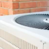 First-Time Homeowner Says Stale AC Smell After Two-Year Vacancy Points to Filters, Coil Buildup and Drainage Problems That Can Make Older Systems Costly to Run Homeowner checking an air conditioner filter after a musty smell spread through the house