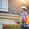 Older Roofs Can Complicate Home Insurance Quotes for Buyers, as Insurers May Inspect After Binding Coverage and Require Repairs Before Keeping the Policy Active A homeowner examining an older roof while reviewing a home insurance quote