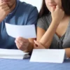 First-Time Buyer Approved for $440,000 Says a $3,600 Mortgage Would Consume Half of Household Take-Home Pay and Leave Little Room for Basics A calculator, house keys and mortgage paperwork on a table