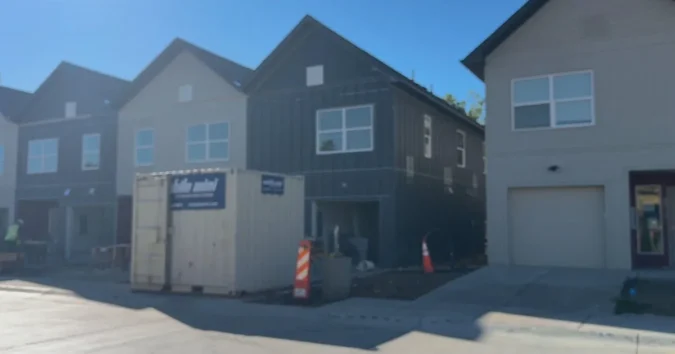 Habitat for Humanity volunteers and future homeowners work on new houses in Arvada