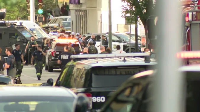 Questions Over Minnesota’s Red Flag Law and Landlord Gun Rules Grow After Downtown Minneapolis Shooting Leaves Three Dead and Six Injured in Midtown Tower Investigation Police tape and emergency vehicles near a downtown Minneapolis shooting scene
