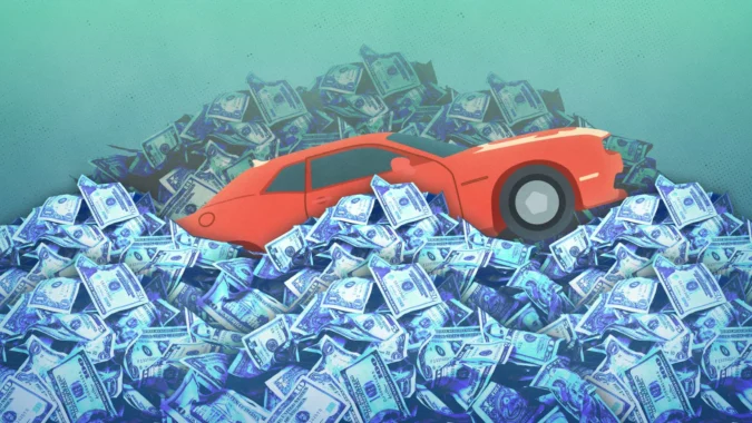A car buyer discussing a trade-in and loan balance with a dealership salesperson