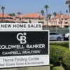 A for-sale house with a mortgage rate sign in front of it