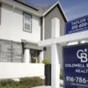 A for sale sign outside a suburban home with the housing market under pressure from higher mortgage rates