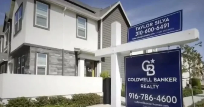 A for sale sign outside a suburban home with the housing market under pressure from higher mortgage rates