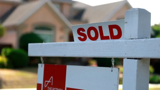 A home for sale sign outside a house as mortgage rates rise above 7 percent
