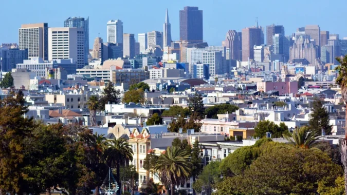 San Francisco Two Bedroom Rent Tops New York City by Nearly 900 Dollars as Zumper Says AI Hiring and Tight Supply Push Prices Higher San Francisco skyline with apartment buildings and a rental market price comparison