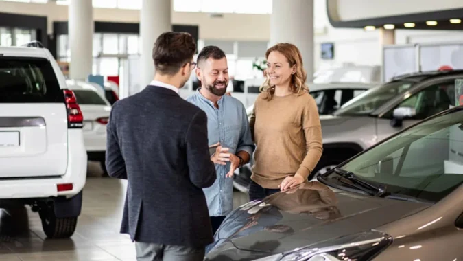 Average Monthly New Car Payment Climbs to $787 as 25.5% of Buyers Take Seven-Year Loans and More Shoppers Finance Four-Figure Monthly Bills Rows of new cars at a dealership with signs highlighting monthly financing payments