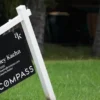 A home for sale sign outside a house as mortgage rates rise and housing demand cools