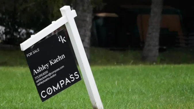 A home for sale sign outside a house as mortgage rates rise and housing demand cools